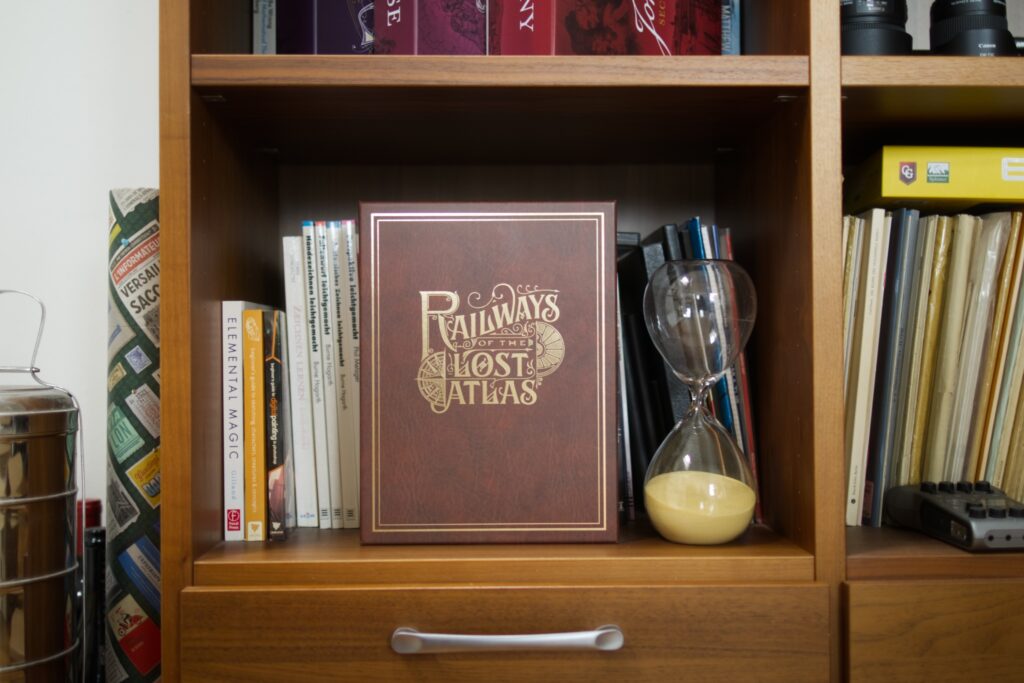 Game box of Railways of the Lost Atlas in a book shelf