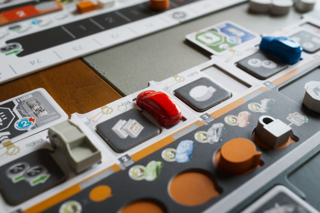 Close up of red metal car on player board in Kanban EV