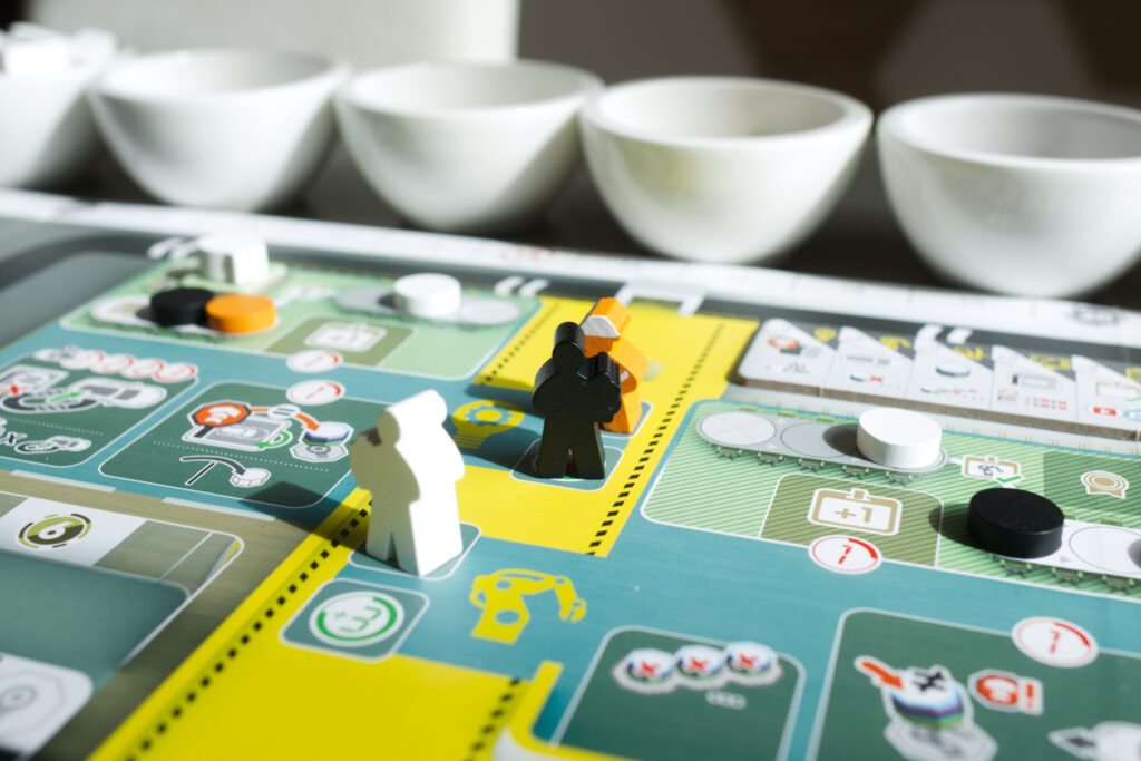 A close up of worker meeples in Kanban EV