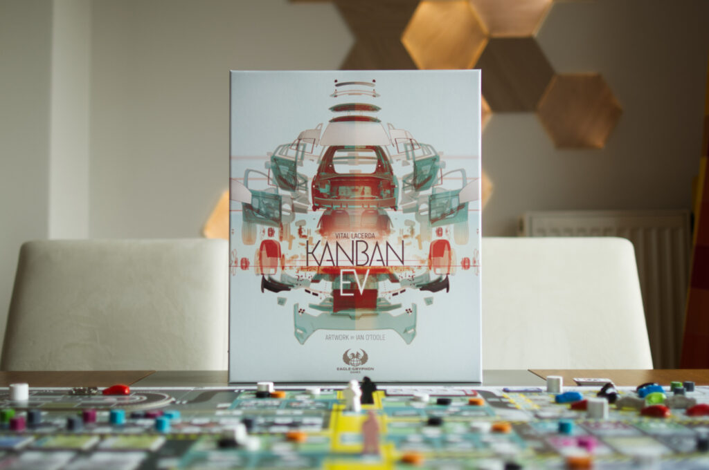 Board game box for Kanban EV by Vital Lacerda with game components in the foreground