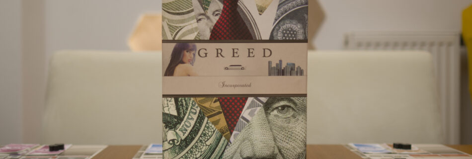Greed Incorporated box with components in front of it
